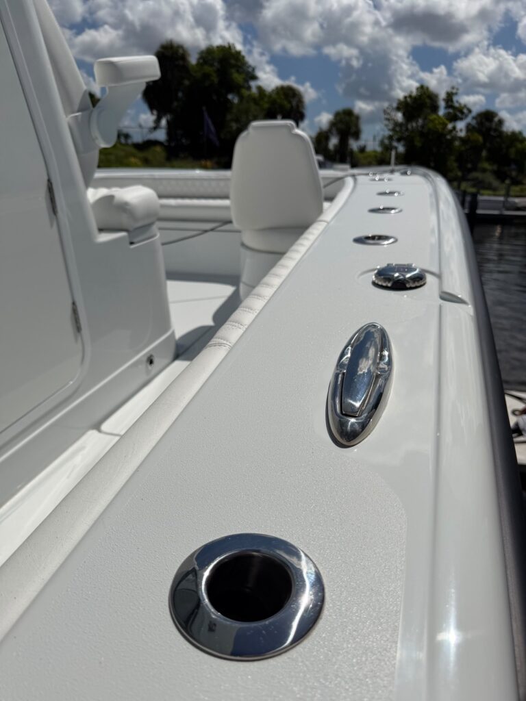 Clean white gunwale and stainless fittings after boat cleaning
